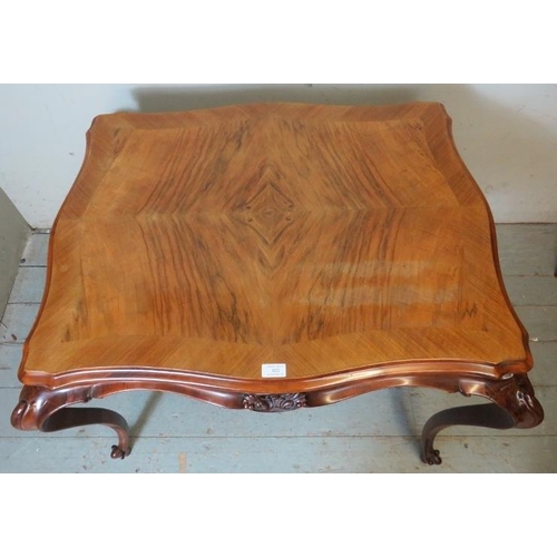 822 - A 19th century style French walnut centre table with quarter veneer serpentine edged top & shaped fr... 