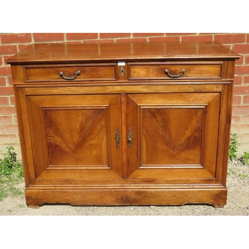 829 - A vintage French fruitwood sideboard with two cutlery drawers over twin cupboard doors opening onto ... 