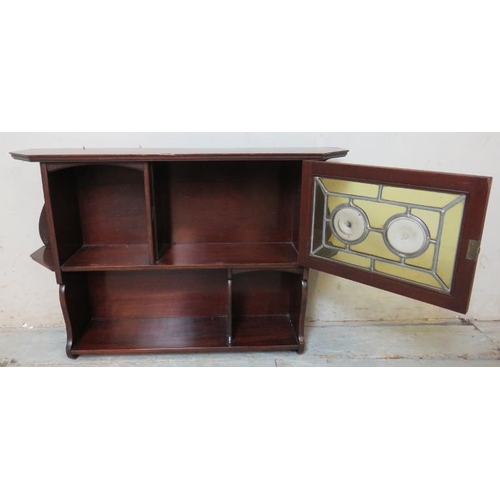 836 - A turn of the century mahogany Arts & Crafts wall hanging shelf with glazed door featuring leaded co... 