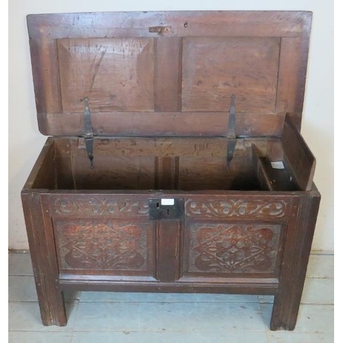 851 - An early 18th century oak coffer of small proportions with internal candle box and carved decoration... 