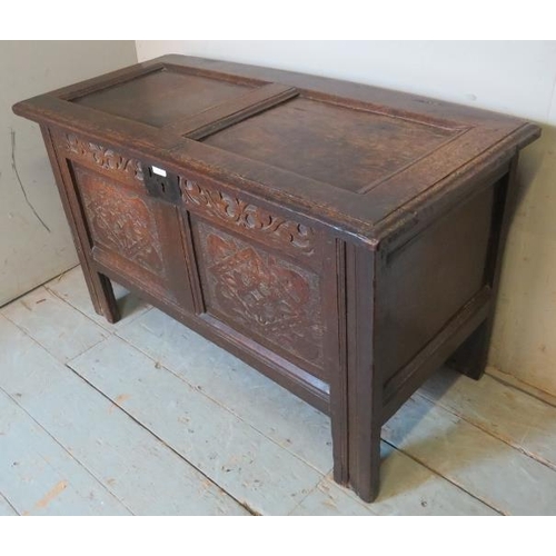 851 - An early 18th century oak coffer of small proportions with internal candle box and carved decoration... 