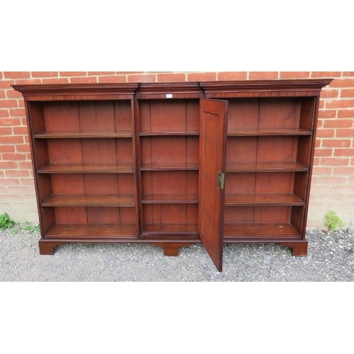 864 - A Georgian mahogany reverse breakfront bookcase, inlaid and crossbanded, housing an array of eight f... 