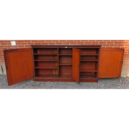 865 - A Georgian mahogany inlaid and crossbanded enclosed low bookcase, the three doors enclosing an array... 