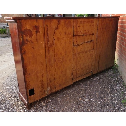 865 - A Georgian mahogany inlaid and crossbanded enclosed low bookcase, the three doors enclosing an array... 