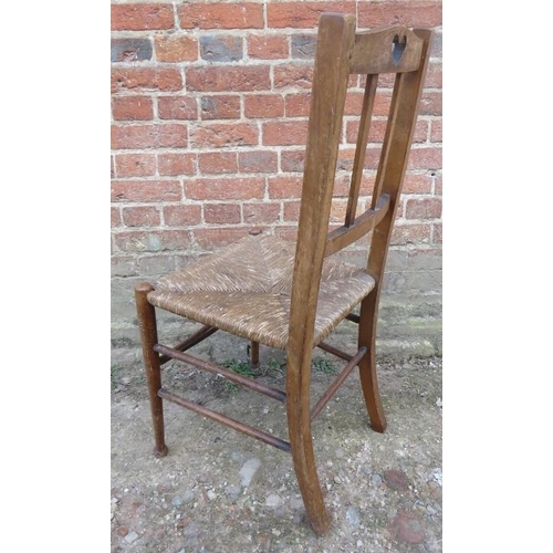 879 - A turn of the century beech country made occasional chair with rush seat & pierced back splat carved... 