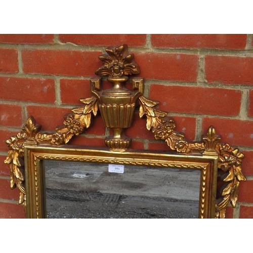 886 - A reproduction giltwood frame rectangular wall mirror with ornate cornice decoration in a neo-classi... 