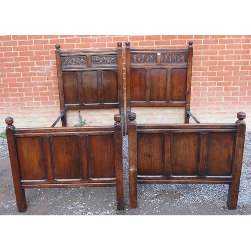 898 - A pair of 18th century style oak single bedsteads, with turned wooden finials & carved decoration to... 