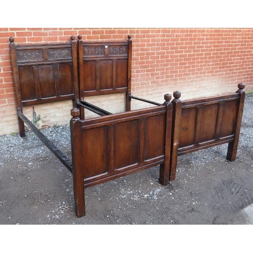 898 - A pair of 18th century style oak single bedsteads, with turned wooden finials & carved decoration to... 