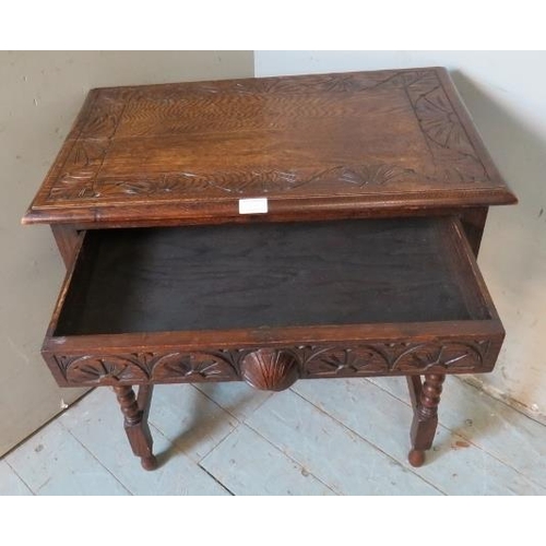 906 - A 19th century style carved oak side table in the Flemish taste with single frieze drawer, raised on... 