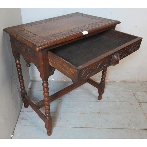 906 - A 19th century style carved oak side table in the Flemish taste with single frieze drawer, raised on... 