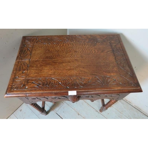 906 - A 19th century style carved oak side table in the Flemish taste with single frieze drawer, raised on... 