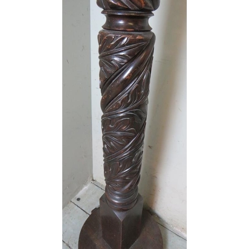 914 - A vintage mahogany standard lamp with heavy carved wrythen column also depicting foliate designs, (a... 