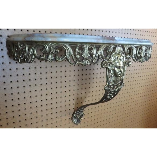 919 - A marble topped gilt metal bracket wall shelf, ornately cast with scrolled motifs in the Rococo tast... 