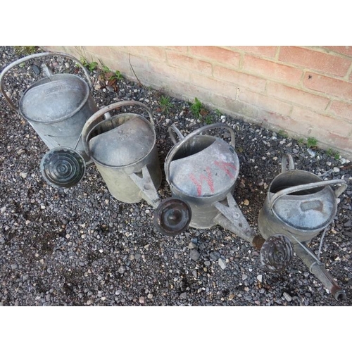 930 - Four vintage galvanized watering cans, three with rose attachments.
Condition report: Some minor den... 