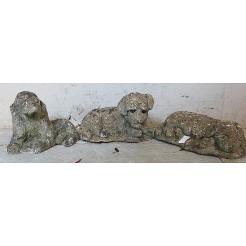 935 - A trio of nicely weathered reconstituted stone garden ornaments in the form of a spaniel, a terrier ... 