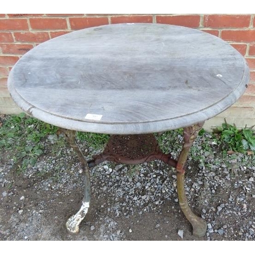 937 - A 19th century cast iron Britannia pub table with an oak top over an ornate cast iron base, raised o... 