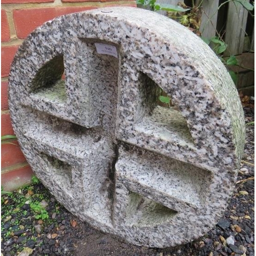 940 - A granite roundel with cruciform pierced centre.
46cm diameter x 10cm deep (approx).