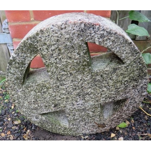 940 - A granite roundel with cruciform pierced centre.
46cm diameter x 10cm deep (approx).