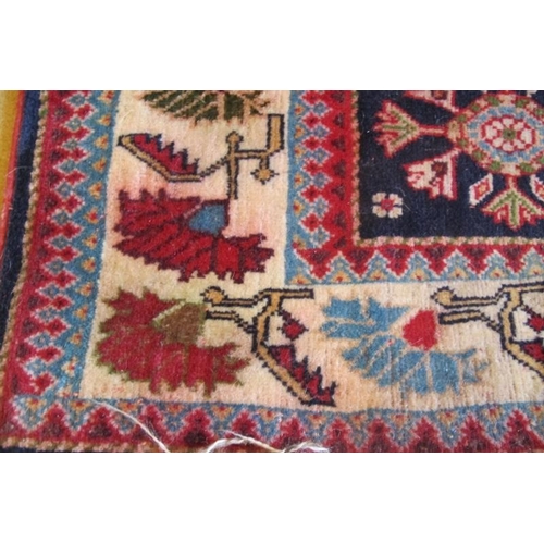 952 - A 20th Century Iranian rug with central blue motif on red ground and cream border. 140cm x 100cm.
Co... 