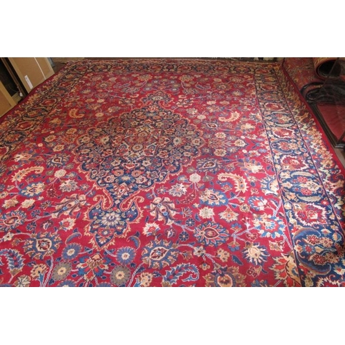 954 - A superb signed meshed carpet on red ground with a central patterned panel in blue and borders. 400c... 