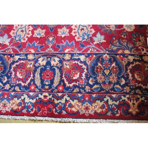 954 - A superb signed meshed carpet on red ground with a central patterned panel in blue and borders. 400c... 