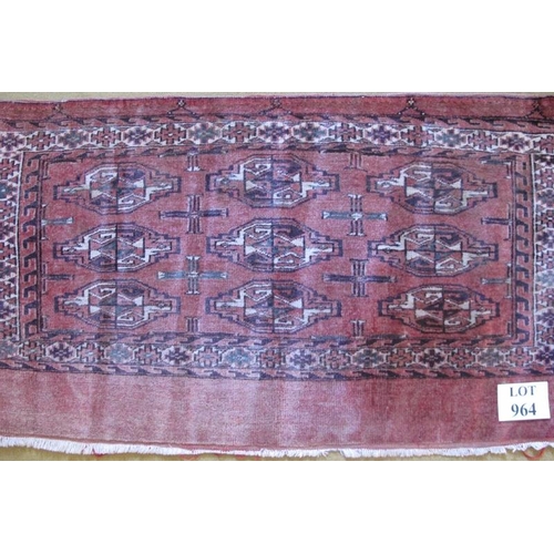 964 - A small Persian rug/panel on pink ground. 128cm x 68cm.