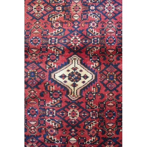 968 - A Persian Hamadan runner cream central motif on claret ground. 217cm x 85cm.
Condition report: Good ... 