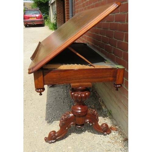 889 - A Victorian architect's desk with adjustable drawing surface, inset with brown tooled leather over a... 