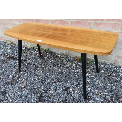 745 - A vintage mid century blonde wood rectangular coffee table with rounded corners, raised on block pai... 