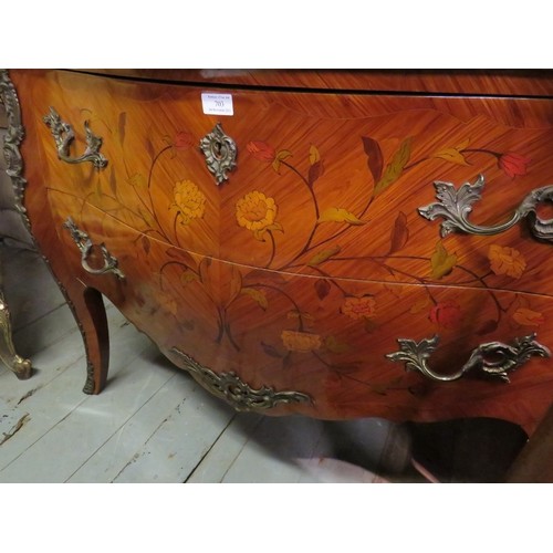 703 - A reproduction 19th century style French tulipwood commode chest featuring black serpentine marble t... 