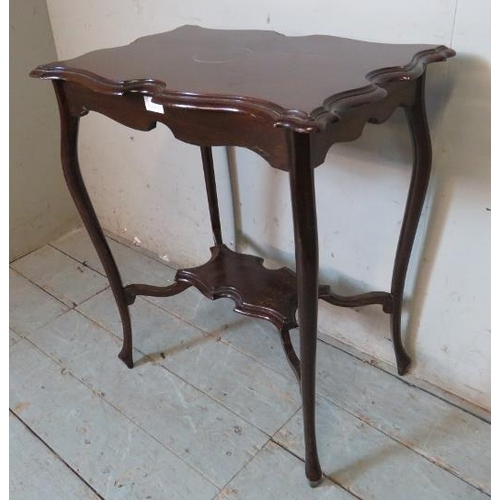 753 - An Edwardian mahogany centre table with shaped top raised on ogee legs with hoof feet, united by a s... 