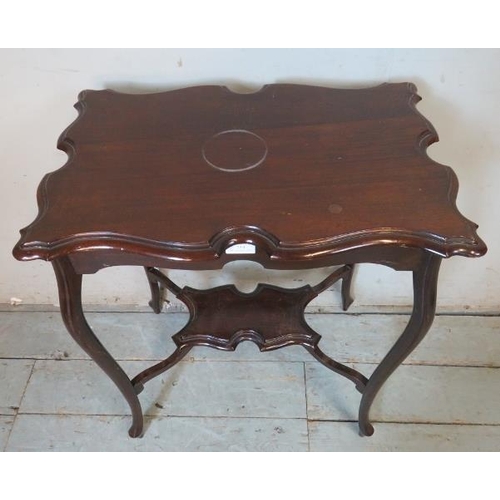753 - An Edwardian mahogany centre table with shaped top raised on ogee legs with hoof feet, united by a s... 