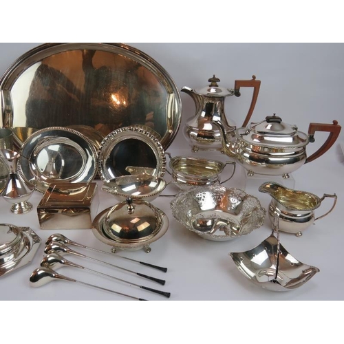 105 - A large selection of mainly silver plated wares including a tea set, platter, cocktail stirrers, etc... 