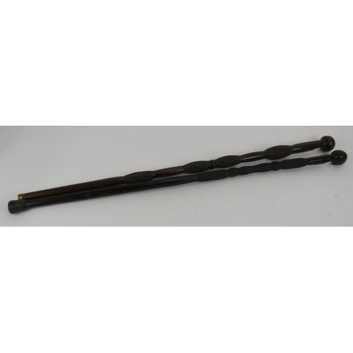 107 - Two African carved knobkerrie sticks, each with diamond carved shafts. Longest 86cm (2).
Condition r... 