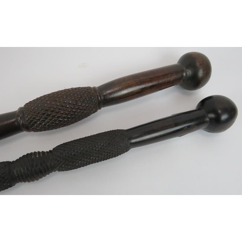 107 - Two African carved knobkerrie sticks, each with diamond carved shafts. Longest 86cm (2).
Condition r... 