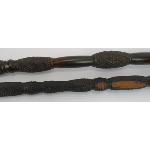 107 - Two African carved knobkerrie sticks, each with diamond carved shafts. Longest 86cm (2).
Condition r... 