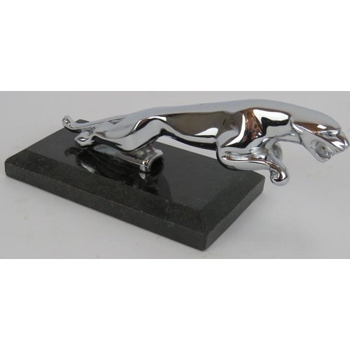 112 - A vintage chrome Jaguar car mascot mounted on a black marble plinth. Mascot length 19cm.
Condition r... 