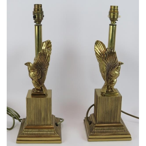 131 - A pair of gilt brass Empire revival style lamps with spread eagles mounted on reeded plinths. Height... 