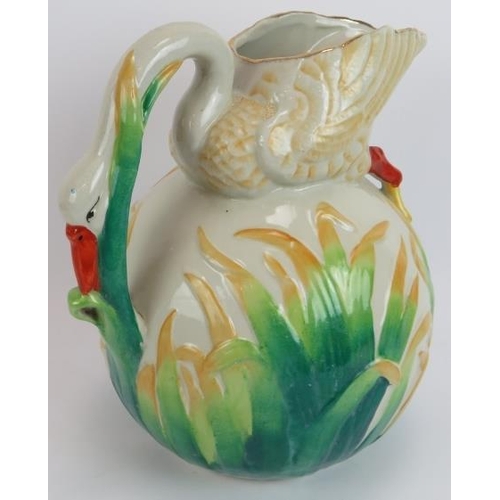 143 - A large Majolica style jug in the form of a feeding swan, a cockerel platter, a fruit decorated bowl... 