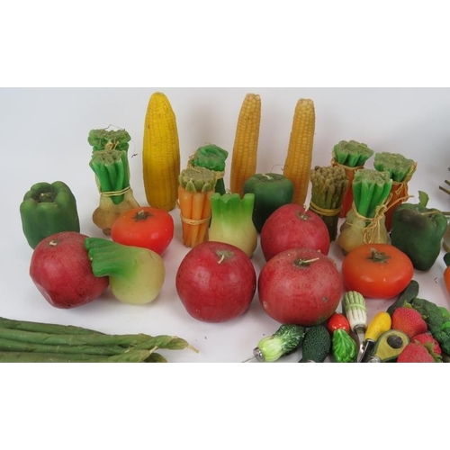 146 - A large quantity of fruit & vegetable shaped candles and similar handled utensils (qty).
Condition r... 