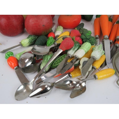 146 - A large quantity of fruit & vegetable shaped candles and similar handled utensils (qty).
Condition r... 