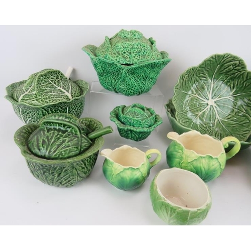 147 - A quantity of Majolica style ceramics fashioned in cabbage leaf designs including four covered turee... 