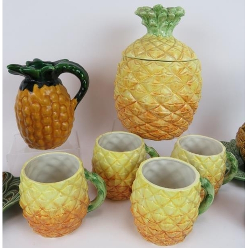 148 - A quantity of Portuguese & Italian ceramics fashioned as pineapples including a five piece mug set a... 