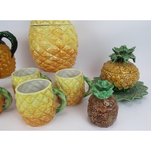 148 - A quantity of Portuguese & Italian ceramics fashioned as pineapples including a five piece mug set a... 