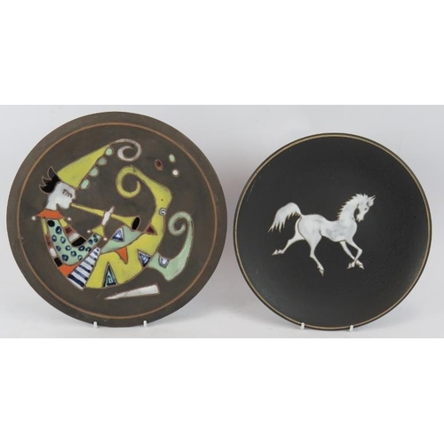 15 - Two 1970s West German decorative plates with enamelled glaze on matt grounds. Largest 24cm (2).
Cond... 