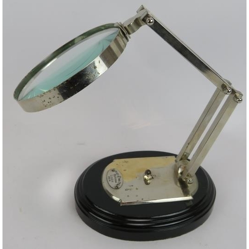 167 - An antique style folding desk magnifying glass on black plinth, labelled for Watts & Sons Ltd Optici... 