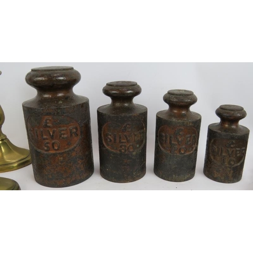 195 - A set of four vintage bank money weights, a selection of horse brasses, pair of brass candlesticks a... 