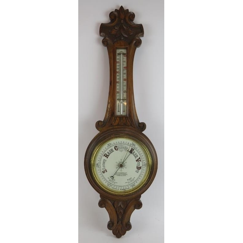 207 - An Edwardian carved oak cased wheel barometer by Aitcheson & Co, London and Leeds. Height 90cm.
Cond... 