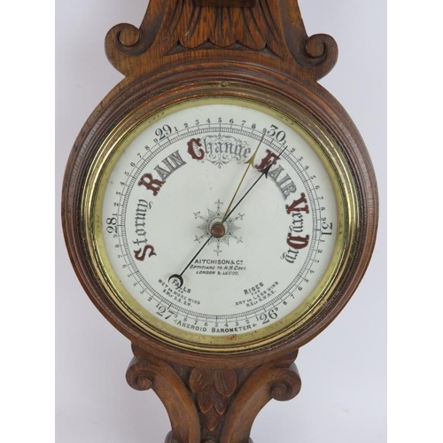 207 - An Edwardian carved oak cased wheel barometer by Aitcheson & Co, London and Leeds. Height 90cm.
Cond... 