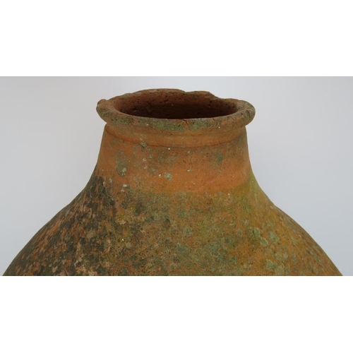 210 - A large antique hand thrown amphora of some considerable age. Height 90cm.
Condition report: One han... 